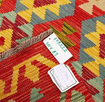 An Afghan kilim runner, c. 301 x 83 cm.