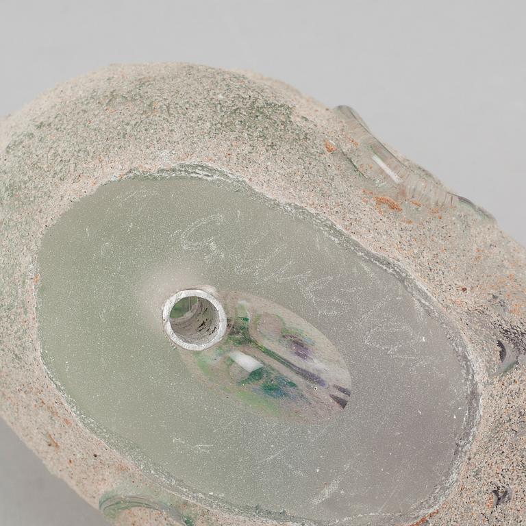 a glass object, signed.