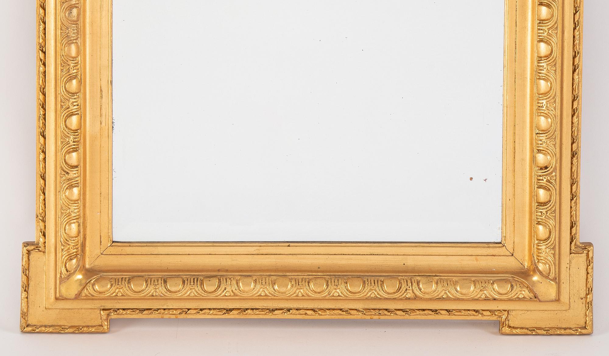 A mirror and console table from around the year 1900.