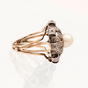 A ring set with a cultured pearl and rose-cut diamonds.