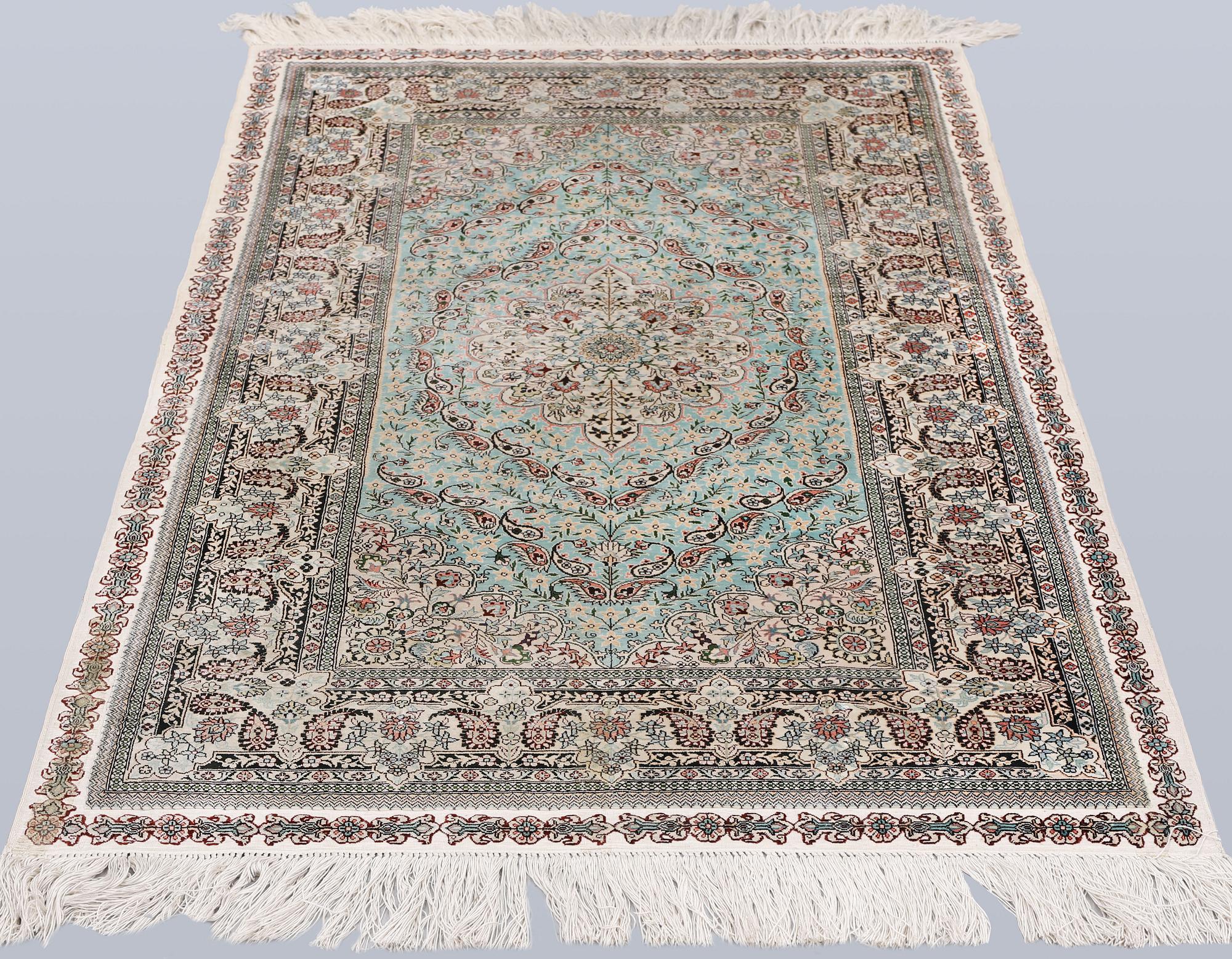 An Oriental silk rug, approx. 154 x 91 cm.