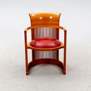 A cherry wood model 606 'Barrel' chair by Frank Lloyd Wright from Cassina.
