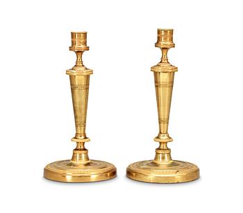 528. A pair of French Empire early 19th Century candlesticks.