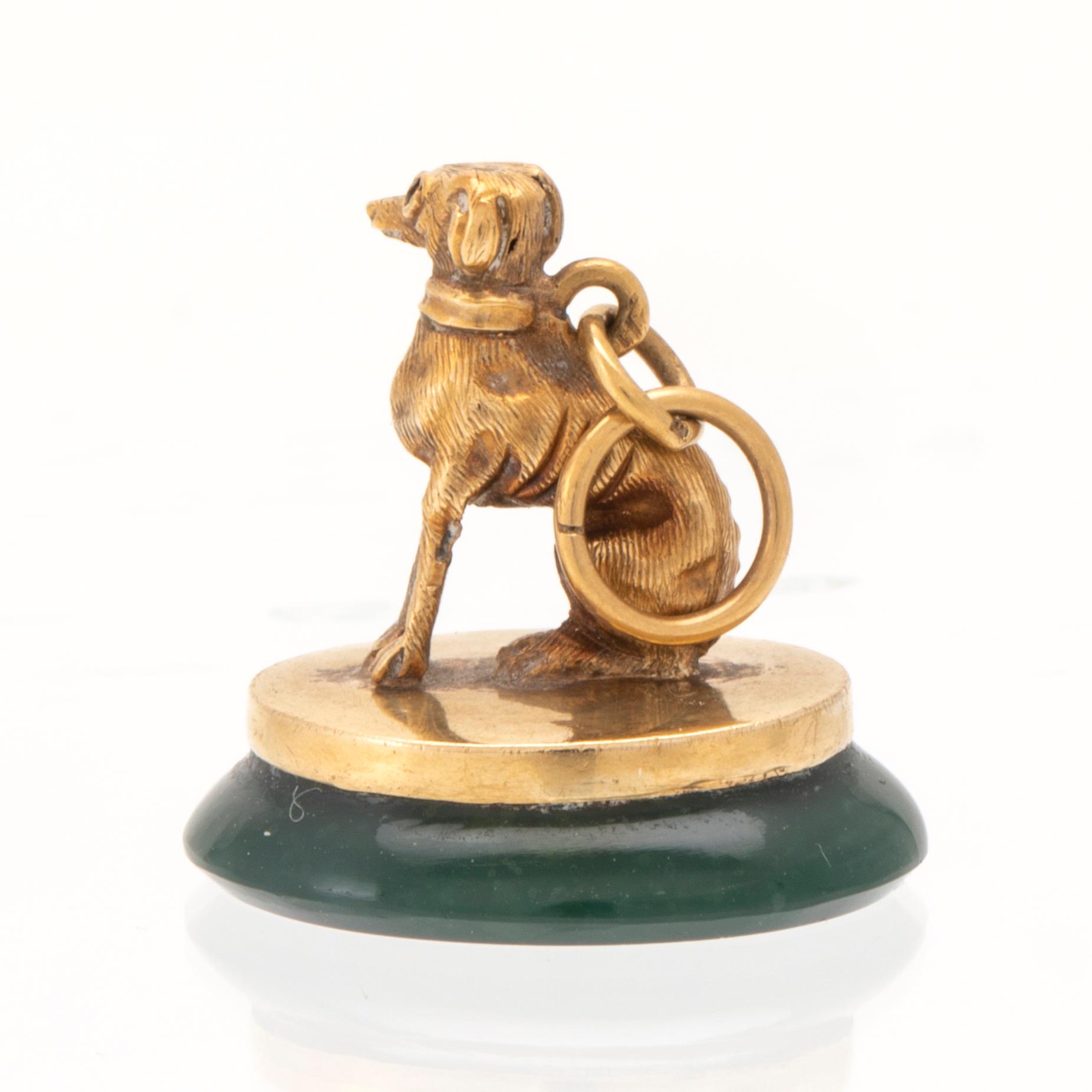 An 18K gold seal/pendant with green stone.