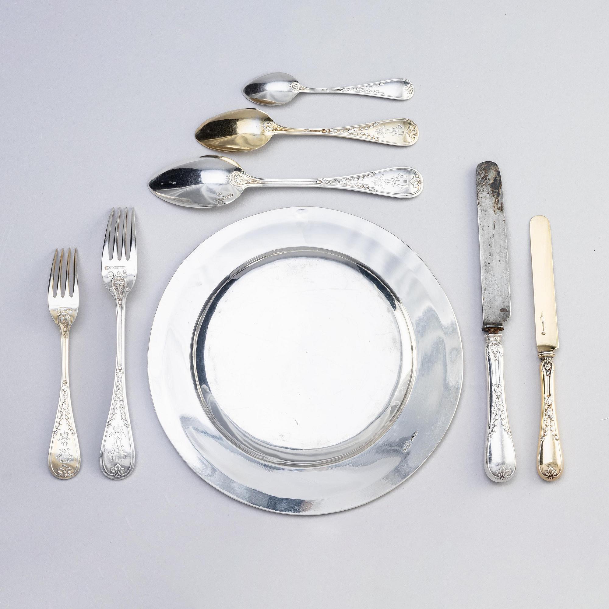 An Imperial Silver Dinner-service, 6 plates and 42 pieces of cutlery, mark of Grachev, St.Petersburg 1882-83 and Sazikov.
