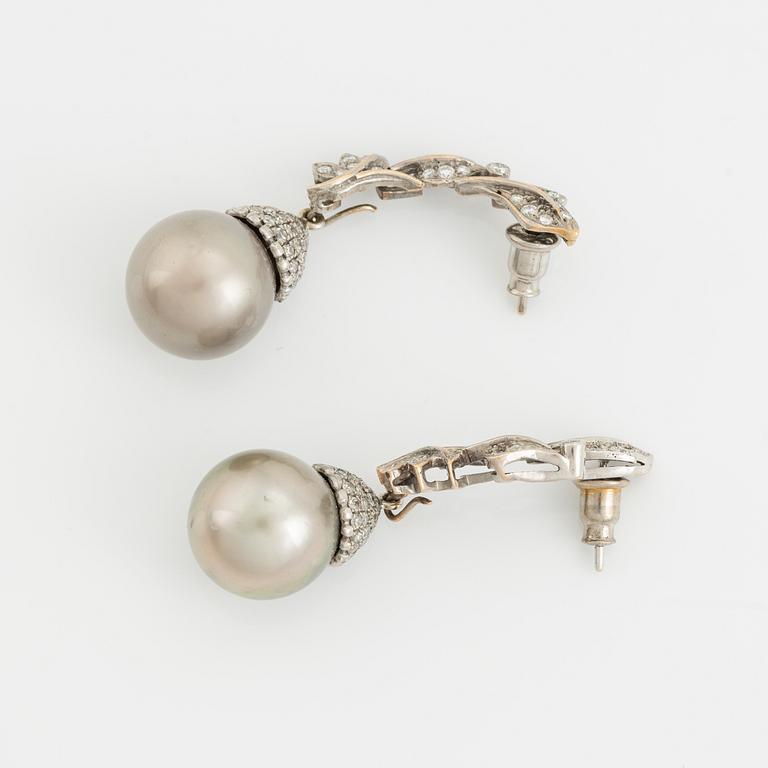 White gold, Tahiti pearl and brilliant cut diamond earrings.