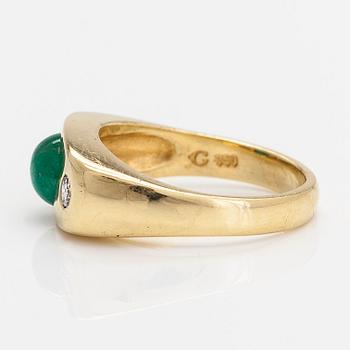 An 18K gold ring, with a cabochon-cut emerald and diamonds totalling approximately 0.18 ct.