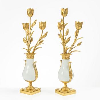 A pair of three light porcelain and gilt bronze three-branch Louis XV-style candelabra, mid 19th century.