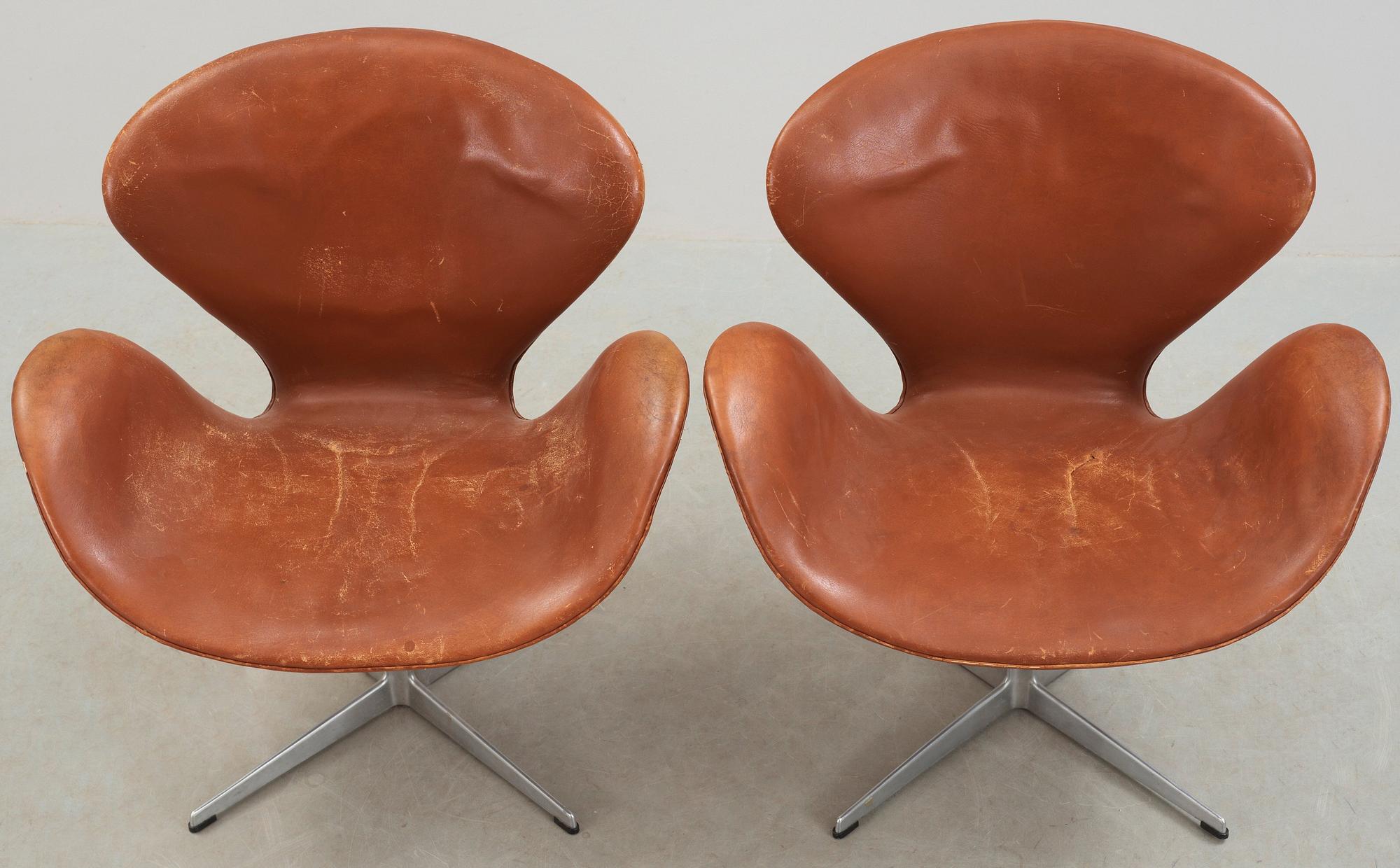 A pair of Arne Jacobsen brown leather 'Swan' chairs, Fritz Hansen, Denmark 1972.