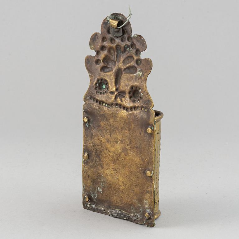 A 17th century brass spoon holder.
