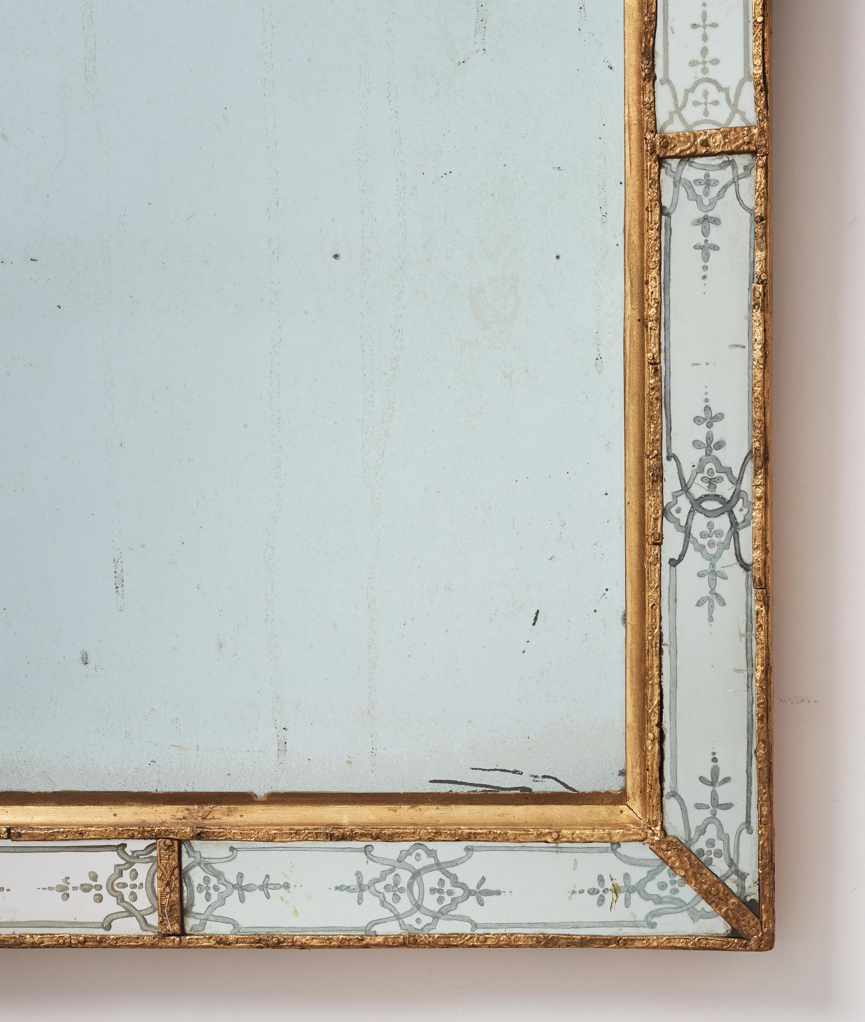 A Baroque gilt-lead and engraved glass mirror in the manner of Burchard Precht, early 18th century.
