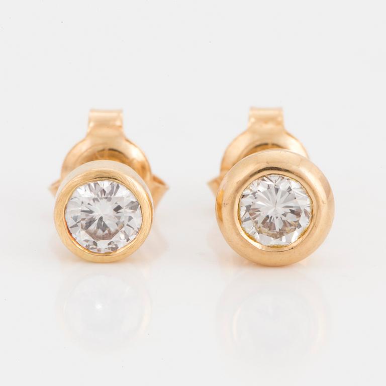 Two earrings with brilliant-cut diamonds.