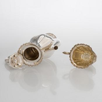 A silver coffee pot, sugar bowl, cream jug, and sugar tongs, Finland 1926-49.