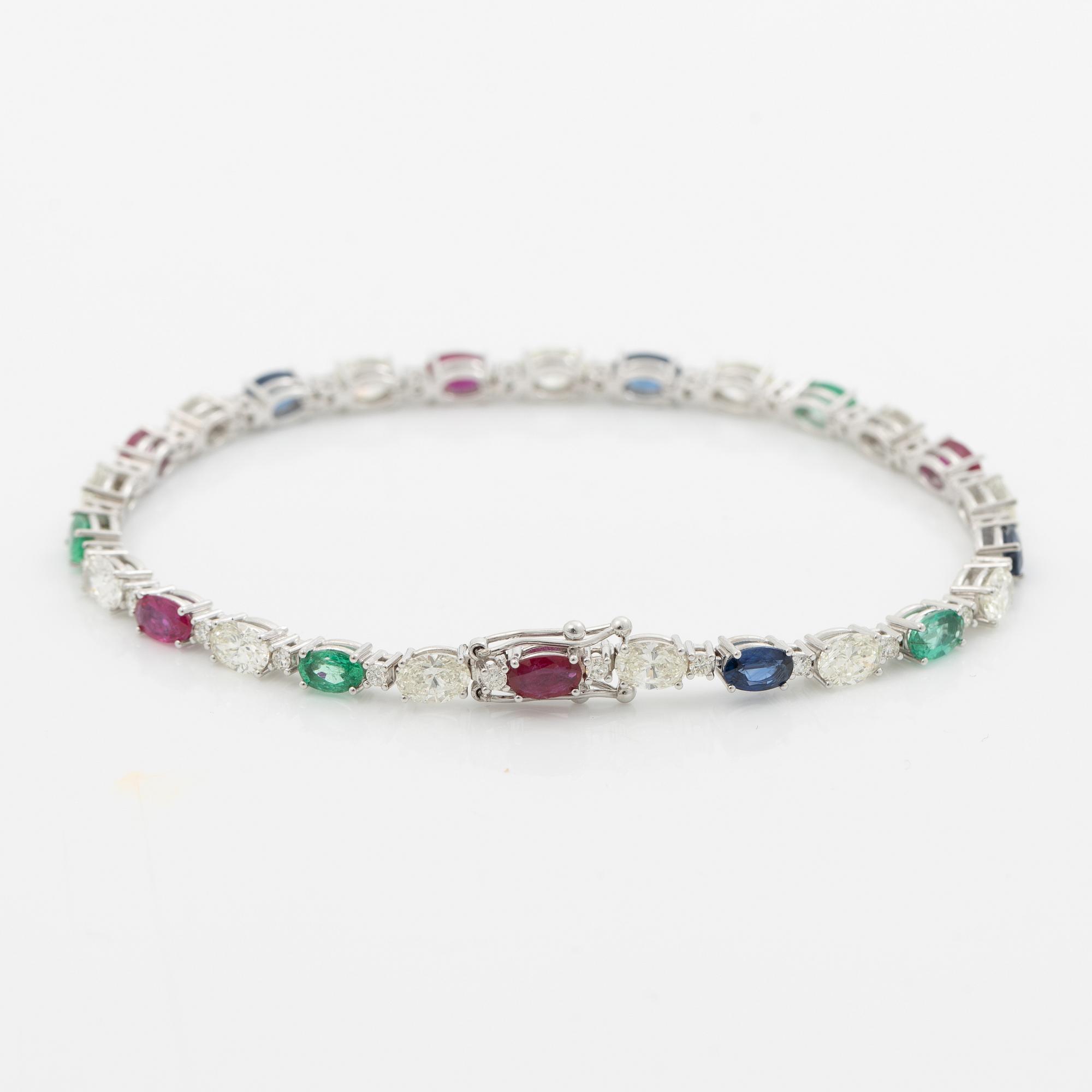 Bracelet 18K white gold set with faceted rubies, emeralds, sapphires, and round brilliant-cut diamonds.