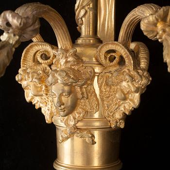 A pair of Louis XVI-style 19th century gilt bronze three-light wall-lights.