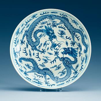 1938. A large blue and white with five clawed dragon dish, Qing dynasty with Guangxu mark.