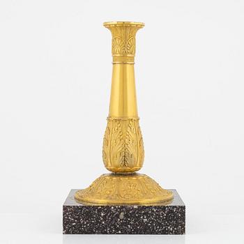 A bronze and porphyry candlestick, 20th Century.