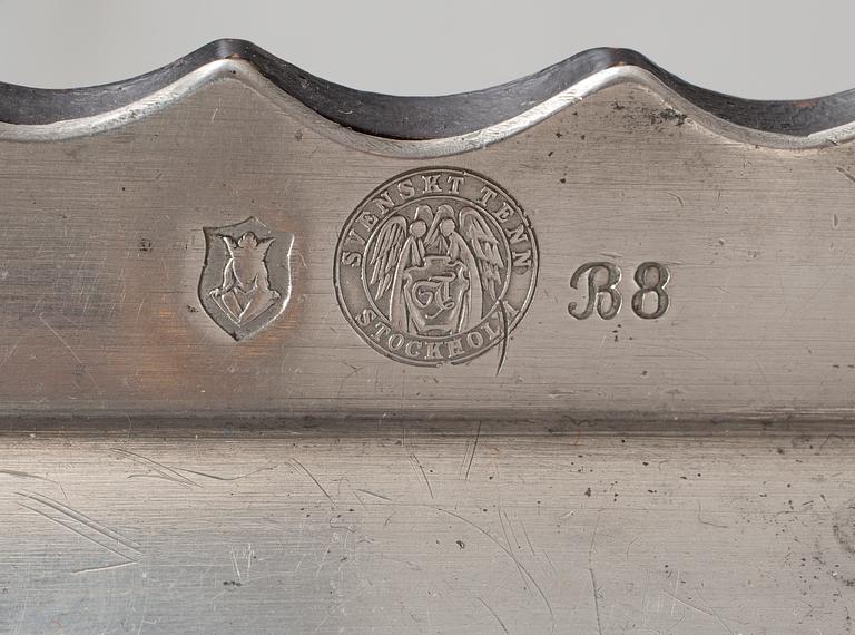 A Firma Svenskt Tenn pewter tray on a birch base, Stockholm 1928.