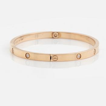 A Cartier "Love" bracelet small model in 18K rose gold with ten round brilliant-cut diamonds.