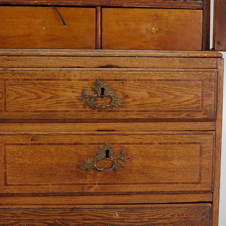 An oak rococo cabinet, mid 18th Century.