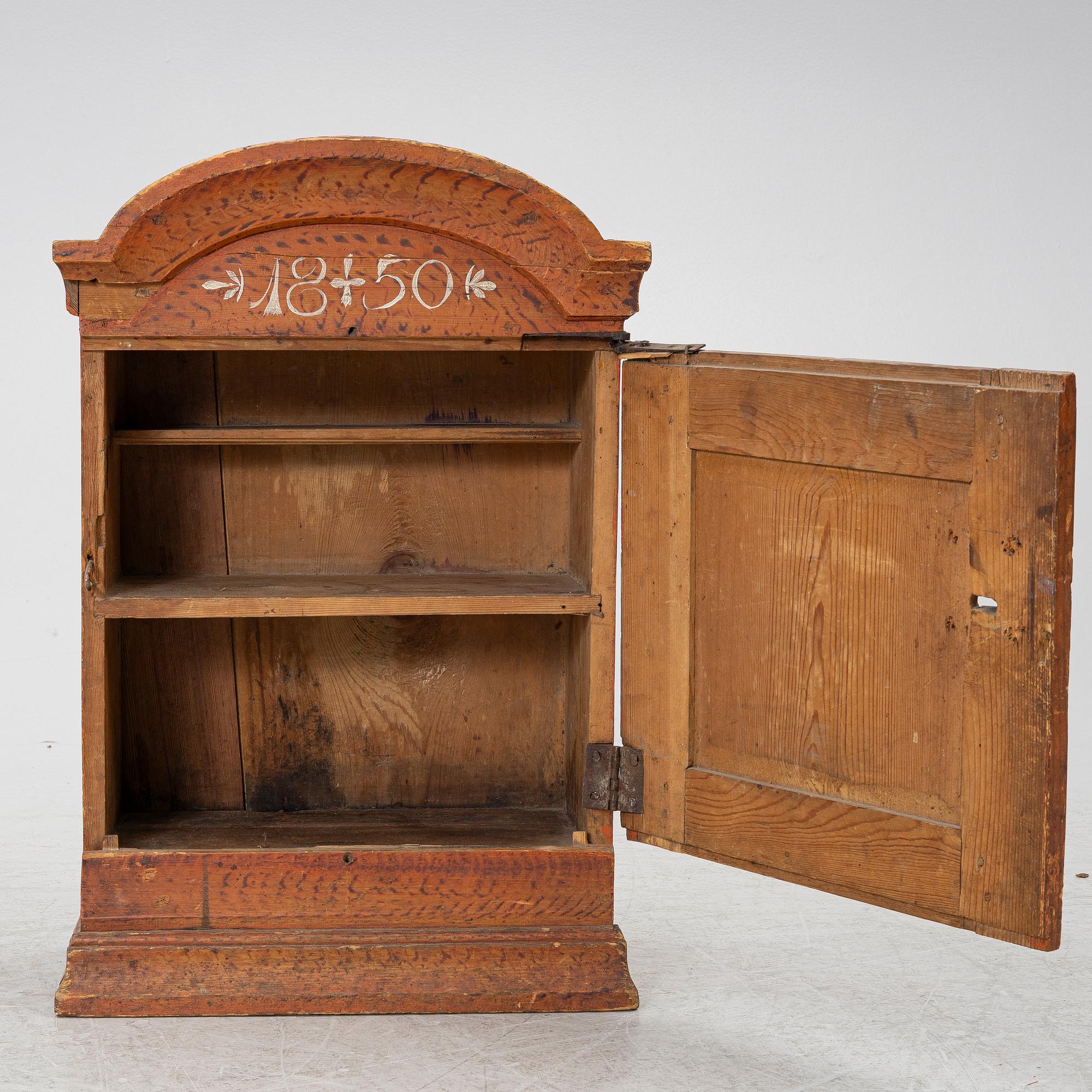 A hanging cabinet, dated 1850.