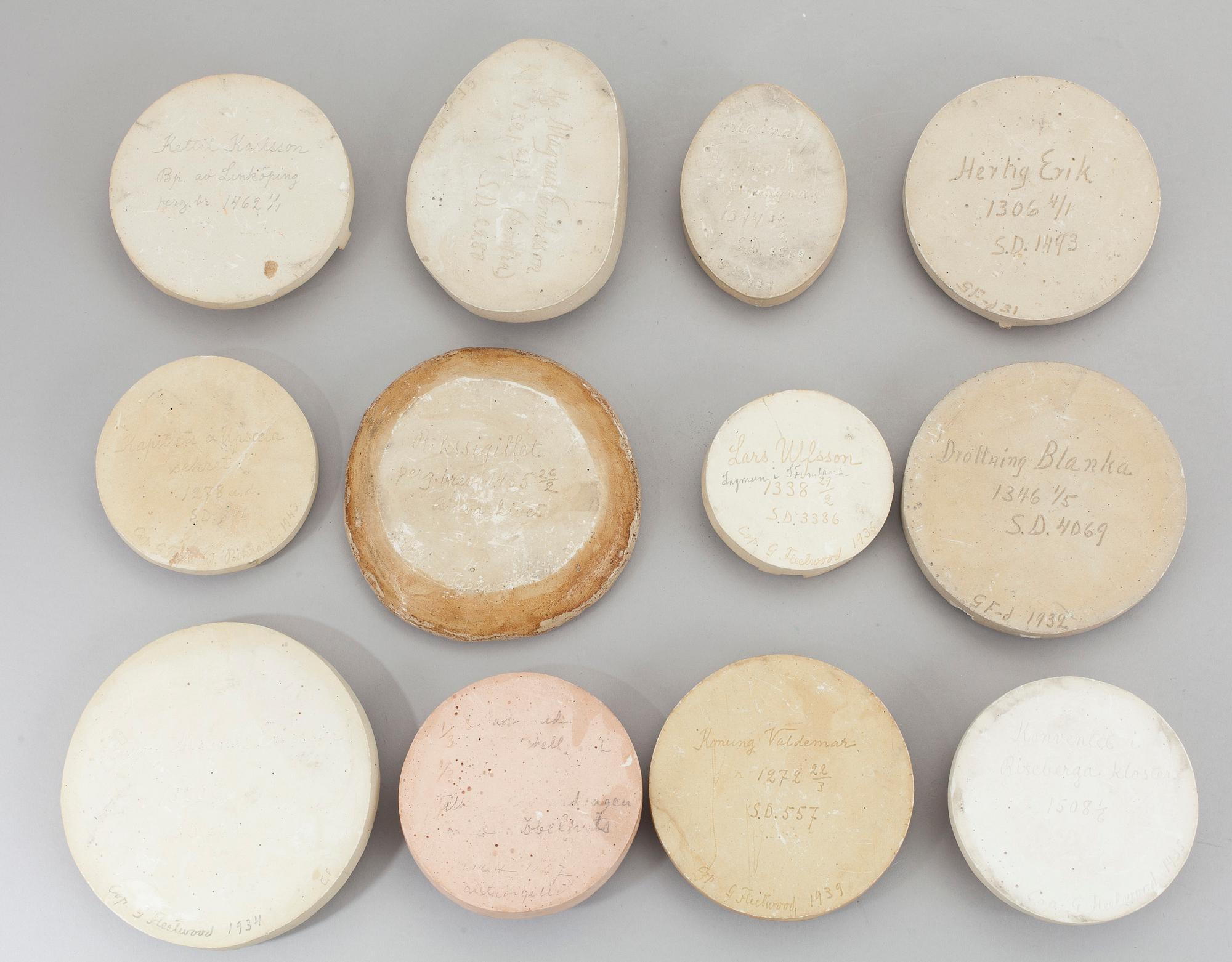 A collection of 12 plaster casts of medieval seals cast by Georg Fleetwood 1930/40s.