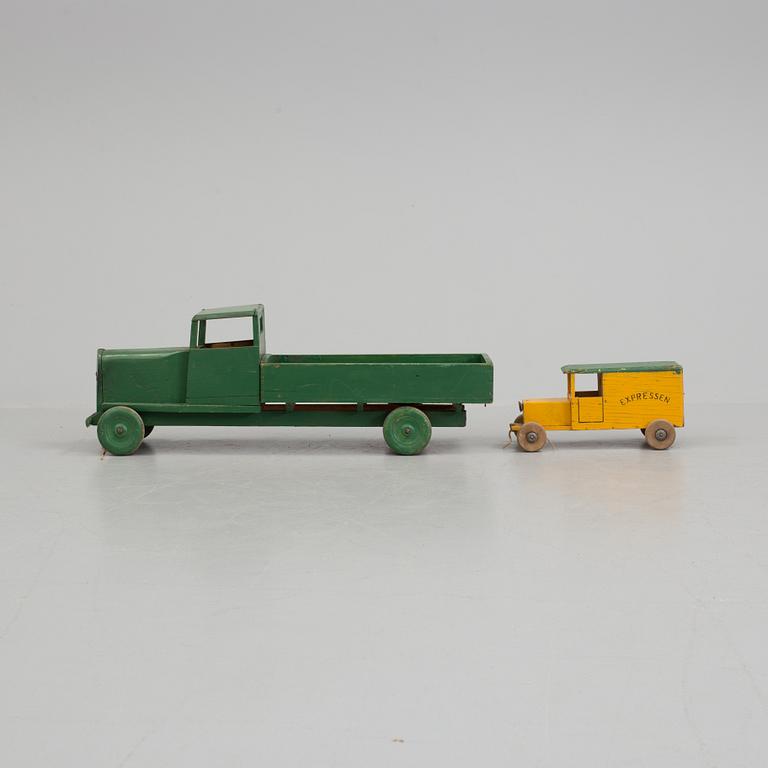 A set of two wooden toy trucks.