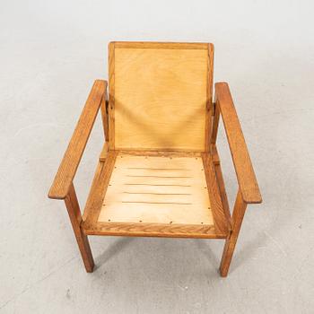 A stained wooden armchair later part of the 20th century.