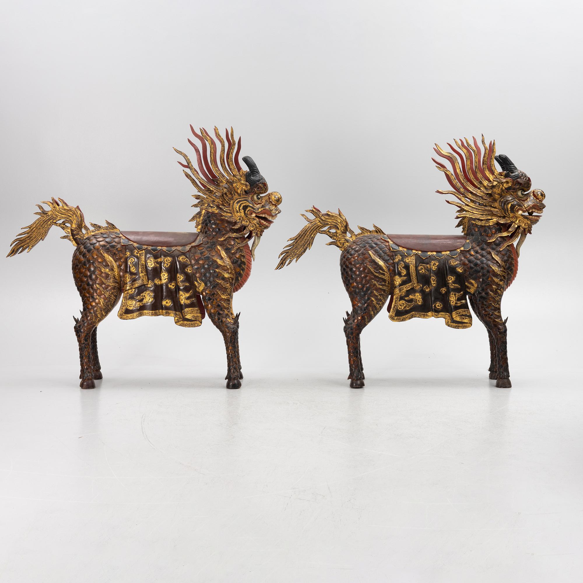 A pair of large Qilin sculptures, lacquered wood, first part of the 20th century.