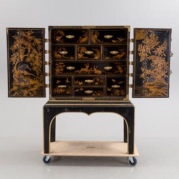 AN early 18TH CENTURY PROBABLY ENGLISH Japanned laquer cabinet on stand.