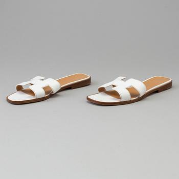 A pair of white leather shoes by Hermès.