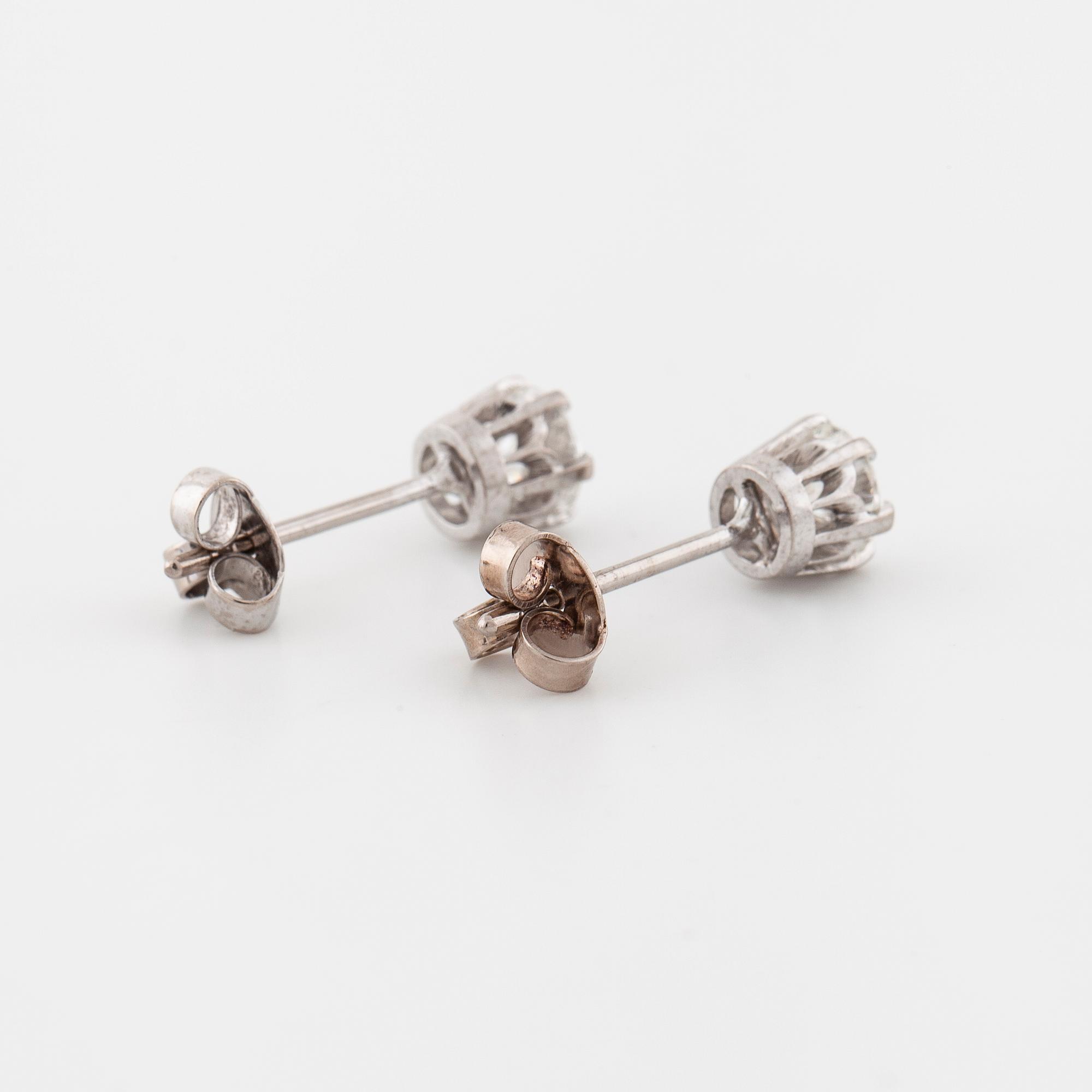A pair of brilliant cut diamond earrings.