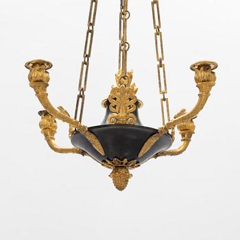 A French Empire ormolu and patinated bronze four-branch chandelier, early 19th century.