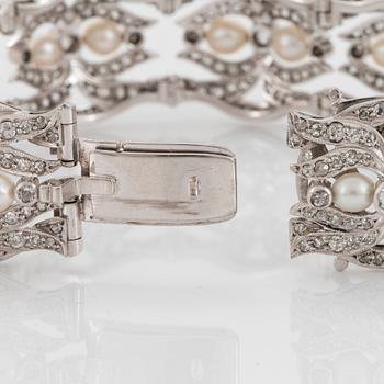 A platinum bracelet and a pair of earrings set with pearls and old-, eight- and rose-cut diamonds.