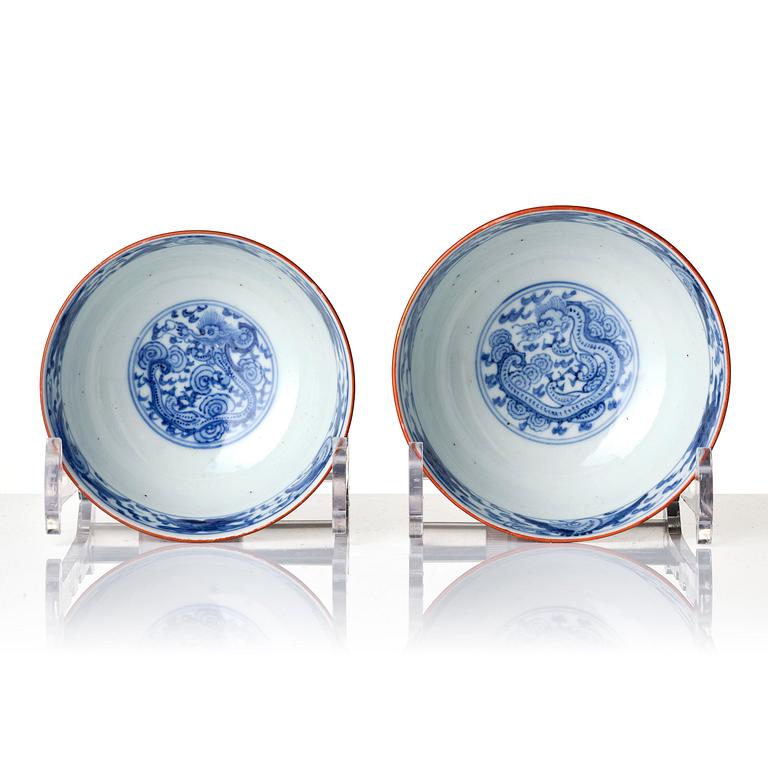 A group of 13 red and gold decorated blue and white bowls with dragon and crane motif, Meiji period (1868-1912).