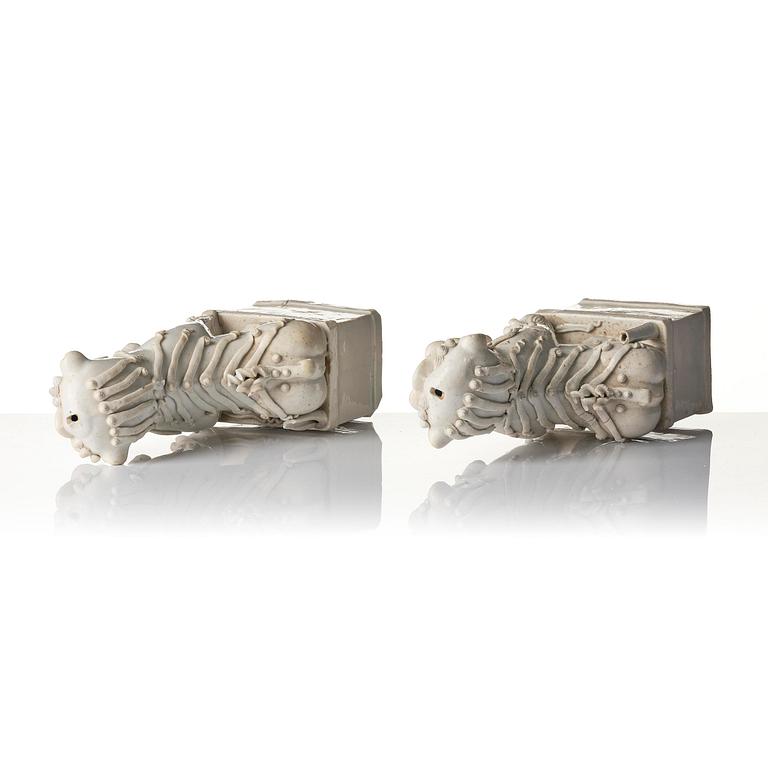 A pair of Chinese blanc de Chine 'Buddhist lion' joss stick holders, Qing dynasty, Kangxi (1662-1722).