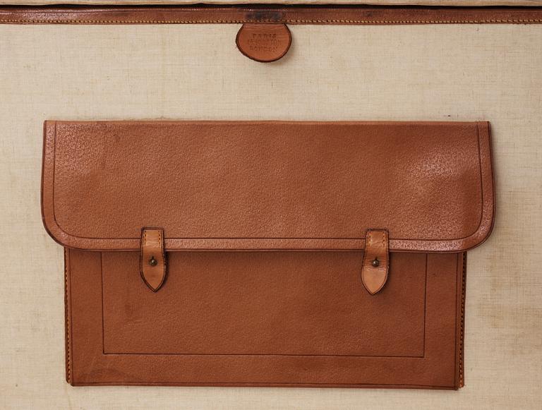 A late 19th cent leather suitcase by Louis Vuitton.