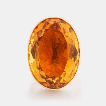 423. A 14K gold ring set with a citrine.