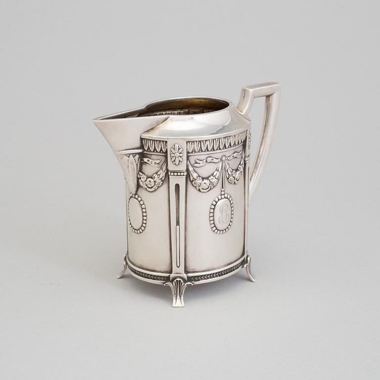 A set of three silver objects (coffeepot, creamer and sugarbowl, CG Hallberg and GAB, Stockholm 1907. Weight ca 1226 gr.