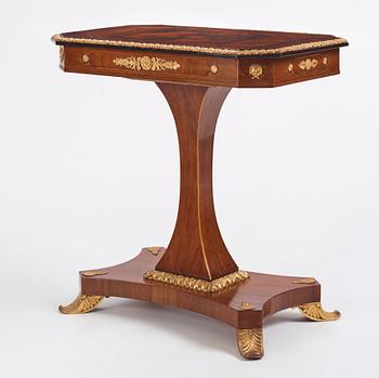 A north european Empire  'Umdruck'-decorated mahogny and gilded metal table.