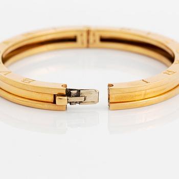 An 18K gold Bulgari bangle.