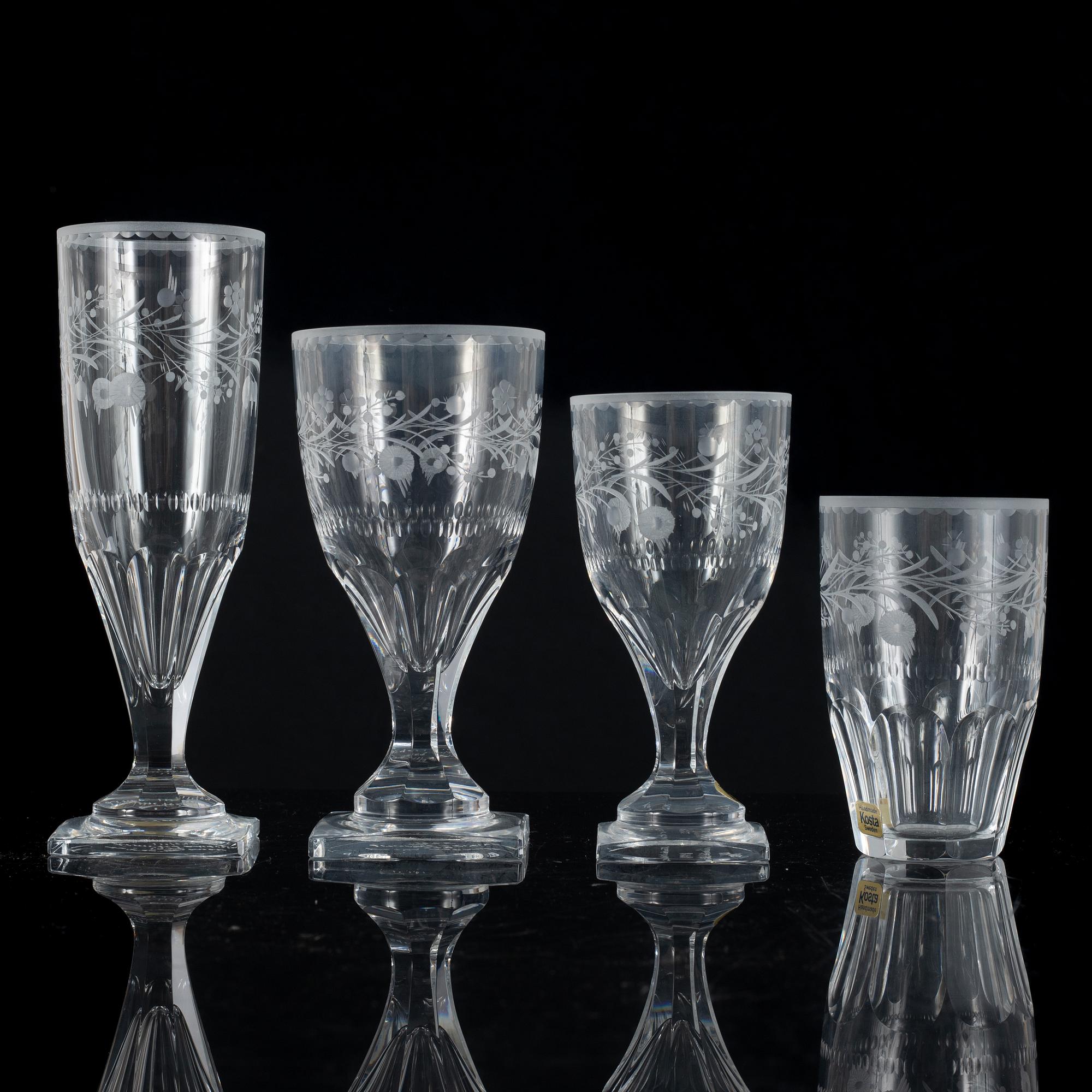 A display cabinet with a 47-piece glass service, "Koskull" from Kosta, Sweden.