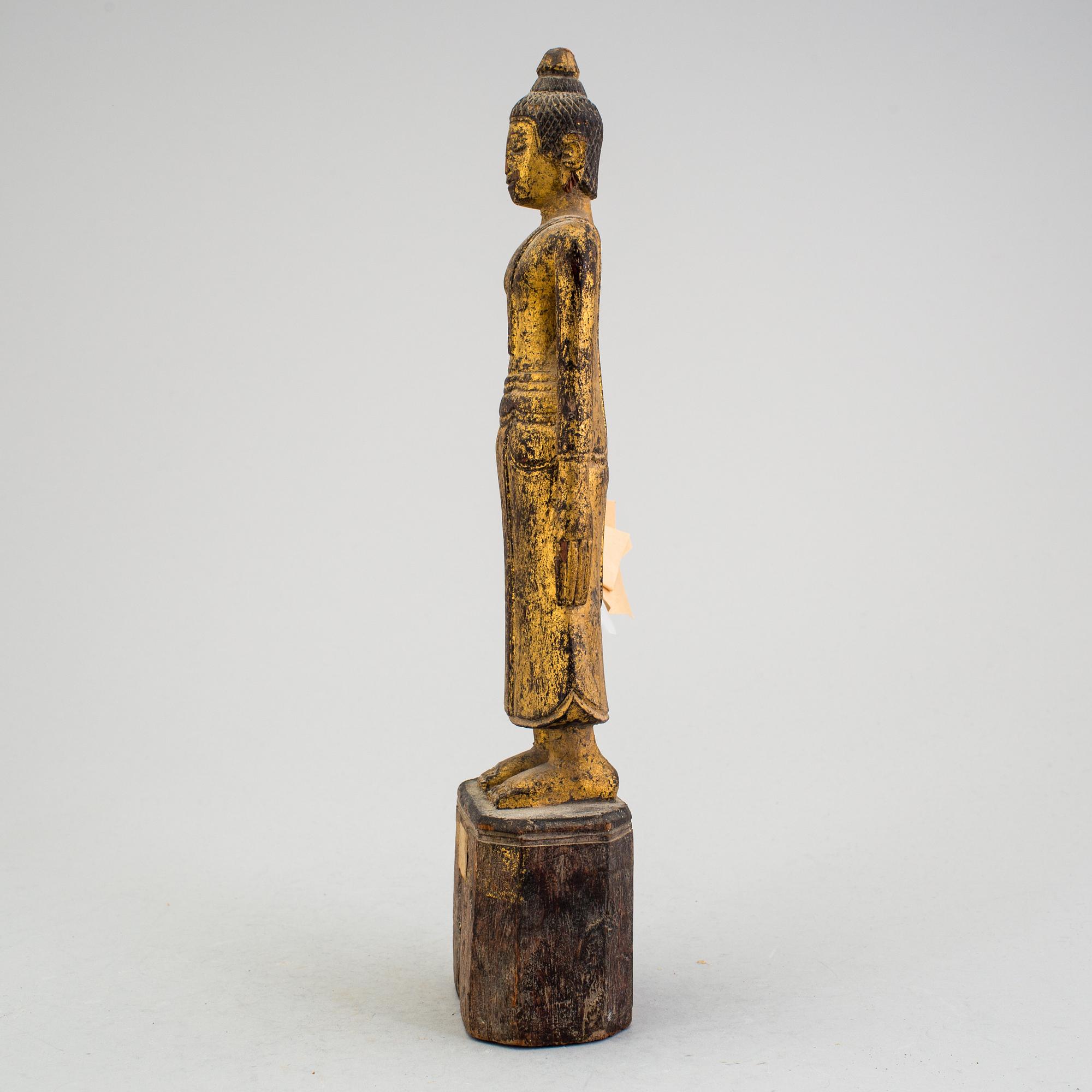 A Burmese sculpture of a standing buddha, circa 1900.