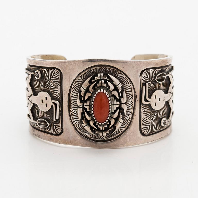 A silver bracelet with coral.