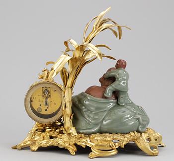 A French Louis XV-style late 19th century table clock.