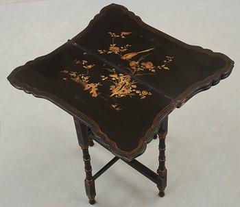 A black and gold laquered games table, 18-19th century.