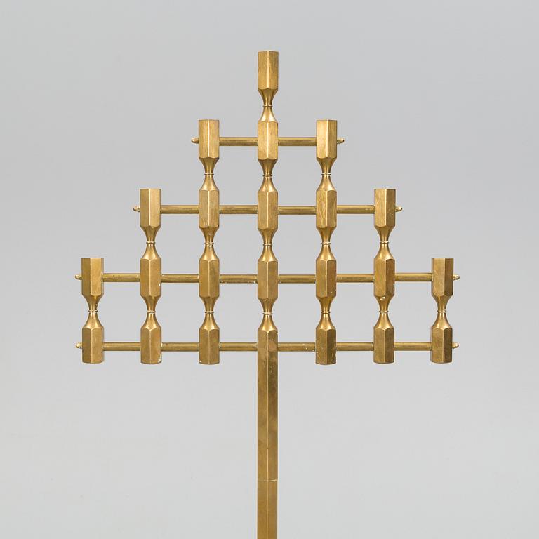 A brass floor candelabrum from Metallslöjden Gusum, signed BK and dated 1989.