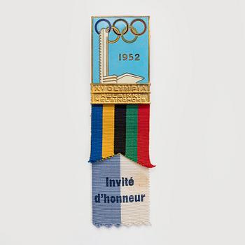 The Finnish olympic cross, 1st class, silver and enamel. Tillander, Helsinki and a Guest of Honor pin.