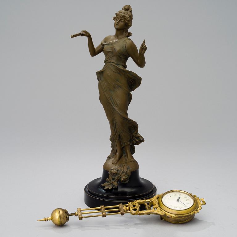 A 1930s Junghans swinger clock with girl sculpture.