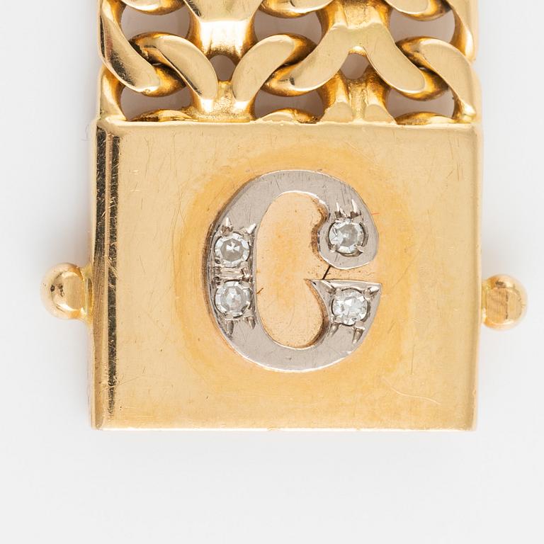Armlänk, 18K guld fiskbenslänk med monogram med diamanter.